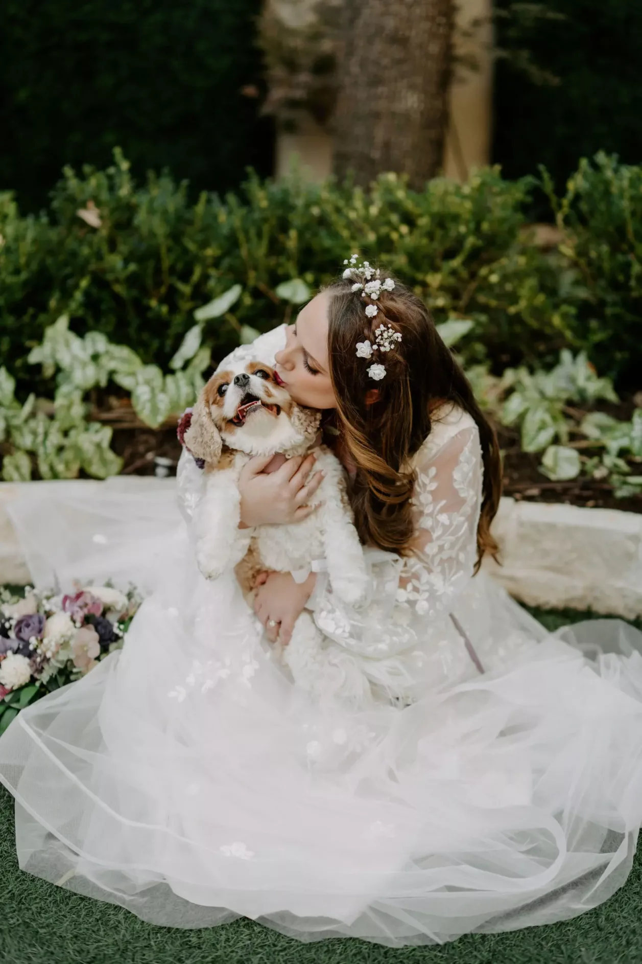 Bride kissing her pup before the ceremony at Magnolia Terrace